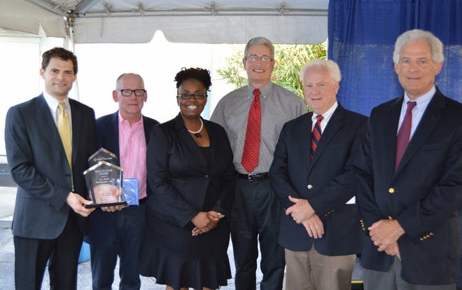 J.C. Lewis Primary Health Care Center CEO Aretha Jones (center) presented special awards to the Center's significant supporters. (L-R) Nelson Lewis, Dr. Ray Rudolph, Aretha Jones, Dr. Gerald Kramer, J. Curtis Lewis, III, and Walter Lewis.