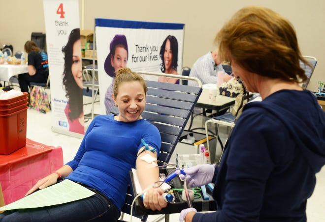 New York Blood Center staff member Jeanne Ritter prepares Courtney Reilly to donate blood during the Mount Saint Mary College Blood Drive. Reilly is a MSMC sophomore from Pleasant Valley. Photo provided