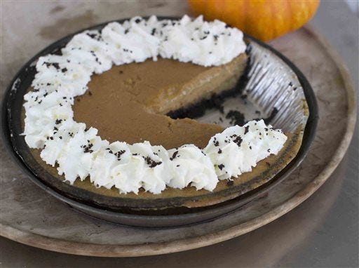 This Oct. 20, 2014, photo shows ultra creamy pumpkin pie in Concord, N.H. The pie has a chocolate crumb pie crust, but the filling will work wonderfully in any crust. (AP Photo/Matthew Mead)