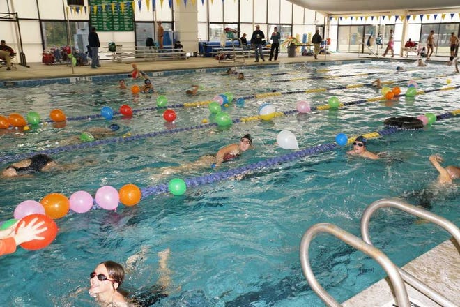 Courtesy of Mary Beth Lyons Fins swimmers in a pool filled with toys and other obstacles during the annual Swim-a-thon on Saturday.