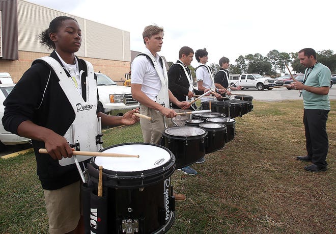 Thibodaux High School drummers Courtney Clark, 16 (from left) Andrew Delcambre, 16, Landon Woodridge, 16, Chris Oubre, 17, and Andrew Rodrigue, 16, practice Wednesday
under the direction of Sam Lecompte for a Showcase Marching Band Festival Saturday in Lafayette.