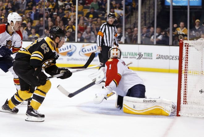 Boston Bruins' Brad Marchand scores the game-winning goal past the Florida Panthers' Roberto Luongo in overtime Tuesday, Nov. 4, 2014. The Bruins won 2-1.