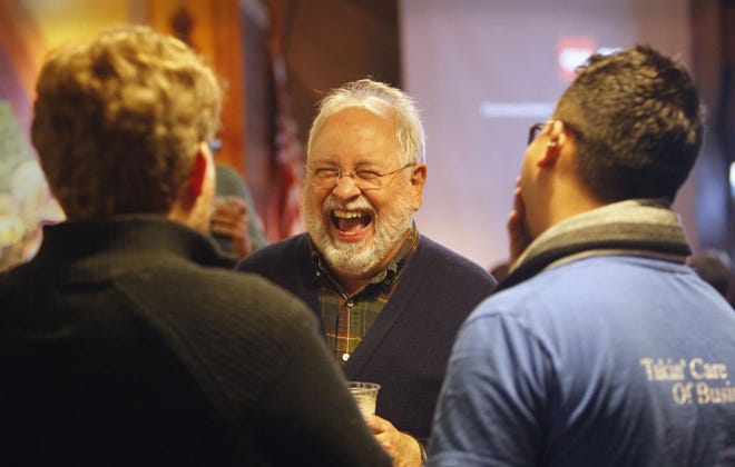 Oregon House District 11 Rep. Phil Barnhart laughs as he talks with supporters at Cozmic Pizza in Eugene on Tuesday, November 4, 2014. (Andy Nelson/The Register-Guard)