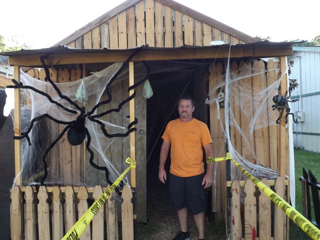 Scott Lee, 45, stands at the entrance of the Haunted House he has built for the past 10 years in his yard for Halloween night.