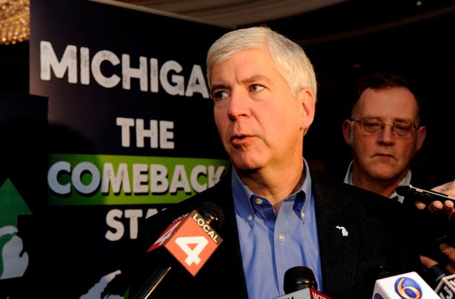 Newly re-elected Michigan Gov. Rick Snyder talks to the media at the Renaissance Center in Detroit, Wednesday morning, Nov. 5, 2014. Snyder says he has a "strong mandate" in a second term despite defeating Democrat Mark Schauer by a smaller margin than when he was first elected in 2010. (AP Photo/Detroit News, David Coates) DETROIT FREE PRESS OUT; HUFFINGTON POST OUT; MAGS OUT; MANDATORY CREDIT