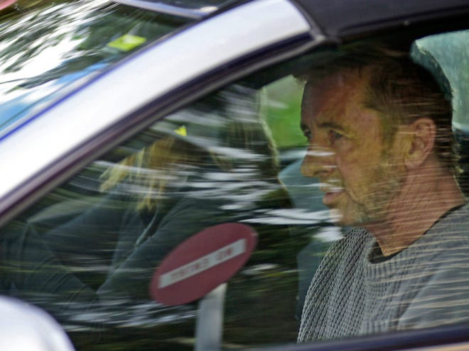 Phil Rudd, the drummer for rock band AC/DC, leaves a court house in Tauranga, New Zealand, Thursday, after being charged with attempting to procure murder. (AP Photo/Bay Of Plenty Times via The New Zealand Herald, George Novak)
