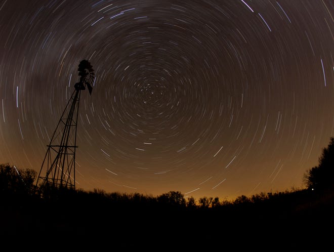 FILE- In this Nov. 7, 2010 file photo, a windmill is silhouetted against a starry sky during a time exposure in a field near Randolph, Kan. Scientists reported Thursday, Nov. 6, 2014, that as many as half of all stars may lie outside galaxies.