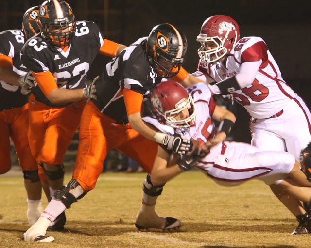 Ruby Dean • Special To Times Record Sallisaw's Kyle Glander stops Muldrow's Braden Scheulen on Friday, Oct. 31, 2014. Sallisaw won the game 35-6.