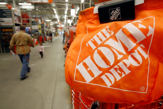 FILE - In this Feb. 22, 2010 file photo, shoppers walk through the aisles at the Home Depot store in Williston, Vt. (AP Photo/Toby Talbot, File)