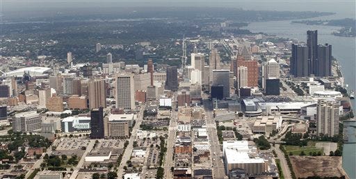 This July 17, 2013 aerial photo shows the city of Detroit. On Friday, Nov. 7, 2014, federal bankruptcy judge Steven Rhodes is expected to decide whether Detroit's plan to exit bankruptcy is fair and feasible. (AP Photo/Paul Sancya, File)