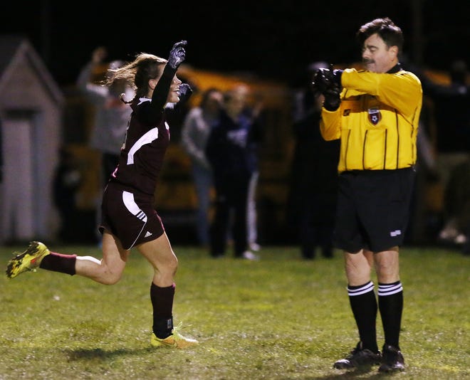 Bishop Stang's Addison Landry sprints to join her celebrating teammates after she scored the winning goal with five seconds left in the second overtime, giving Stang a 2-1 victory over Old Rochester. 

MIKE VALERI/THE STANDARD-TIMES