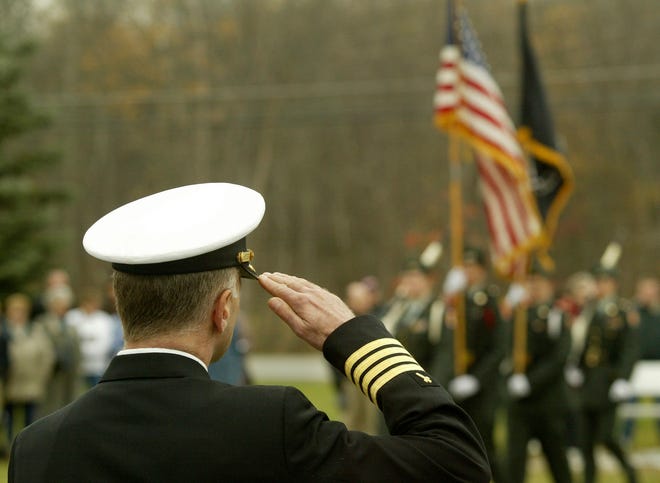A captain in the United States Naval Reserve salutes the flag at the Town of Wawayanda Veterans Day ceremony. File photo