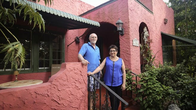 Dulce and Michael MacAndrews at their home in Lake Boynton Estates in Boynton Beach. “It was built in 1926,” said Dulce. (Bruce R. Bennett / The Palm Beach Post)