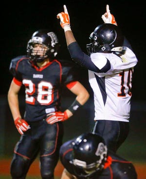 Rossville's Christian Roduner (28) stands in disbelief as Centrailia's Darrian Turner (10) points to the sky after scoring a touchdown to pull the Panthers within two points of tying Rossville in the first half of Saturday night's game in Rossville.