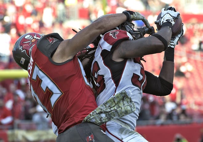 Atlanta strong safety Kemal Ishmael, right, intercepts a pass intended for Tampa Bay wide receiver Vincent Jackson during the fourth quarter Sunday in Tampa.