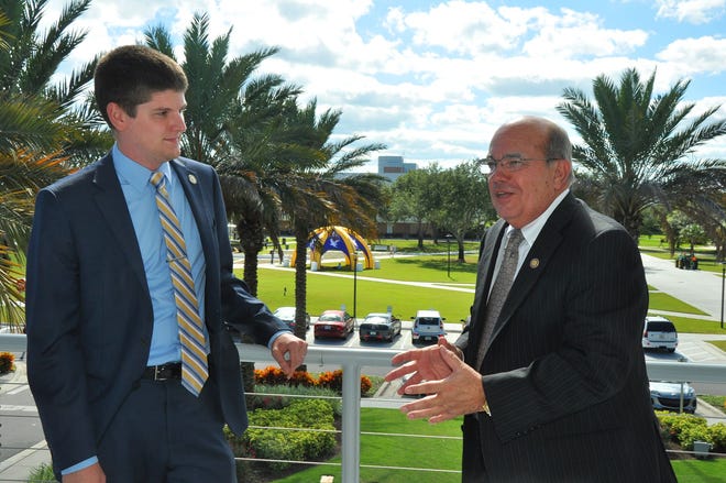 Embry-Riddle Aeronautical University President John Johnson and Andre Prescott, left, president of the Student Government Association, discuss the building projects recently on the campus in Daytona Beach.