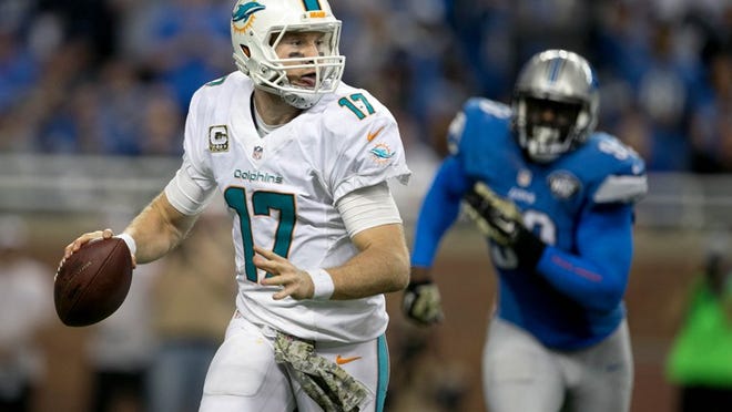 Miami Dolphins quarterback Ryan Tannehill (17) is chased out of the pocket by Detroit Lions defensive end George Johnson (93). Tannehill through an incomplete pass on third down forcing the Dolphins to punt late in the game in at Ford Field in Detroit, Michigan on November 9, 2014. (Allen Eyestone / The Palm Beach Post)