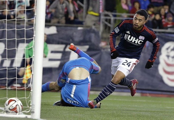 Midfielder Lee Nguyen slips the ball past Crew goalkeeper Steve Clark to give the Revolution a 1-0 lead in the 43rd minute.