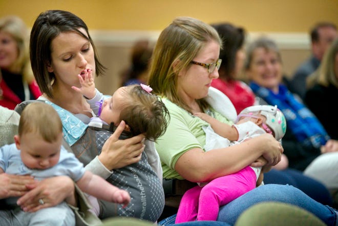 Julie Wilson and daughter, Jovie, left, and Kristyn Jackson and her daughter, Kaidyn, were among those who turned out to show their support for Maegan Shoemaker during Monday night's Okaloosa County School Board meeting.