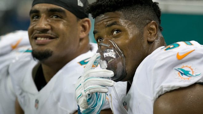 Miami Dolphins defensive end Cameron Wake (91) takes some oxygen after a long drive by the Lions in the first quarter at Ford Field in Detroit, Michigan on November 9, 2014. (Allen Eyestone / The Palm Beach Post)