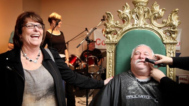 Joanne Stanley (left) laughs as Lantana Mayor David Stewart has his beard shaved off Sunday during a fund-raiser for Forgotten Soldiers Outreach at the Red, White & Buzz Festival at the Lantana Recreational Center. (Richard Graulich / The Palm Beach Post)