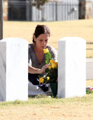 Jamie Mitchell • Times Record / Kim Williams arranges yellow roses at her father's grave site Sunday at the U.S. National Cemetery in Fort Smith. A Veterans Day Ceremony will be 11 a.m. Tuesday with Maj. Jay Mike Akins (Ret.) as the keynote speaker. 
 Jamie Mitchell • Times Record / Kim Williams arranges yellow roses at her father's grave site Sunday at the U.S. National Cemetery in Fort Smith. A Veterans Day Ceremony will be 11 a.m. Tuesday with Maj. Jay Mike Akins (Ret.) as the keynote speaker. 
 Jamie Mitchell • Times Record / Kim Williams arranges yellow roses at her father's grave site Sunday at the U.S. National Cemetery in Fort Smith. A Veterans Day Ceremony will be 11 a.m. Tuesday with Maj. Jay Mike Akins (Ret.) as the keynote speaker.
