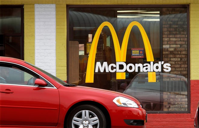 FILE - This Oct. 17, 2011 file photo, cars move through the drive-thru window at a McDonald's in Springfield, Ill. (AP Photo/Seth Perlman, File)