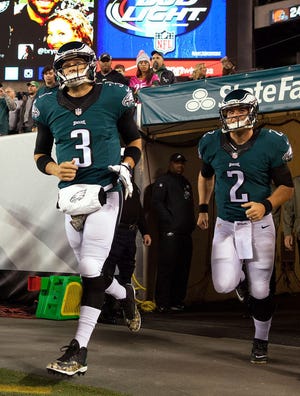 Philadelphia Eagles quarterbacks Mark Sanchez (left) and Matt Barkley take the field for warmups before a game against the Carolina Panthers at Lincoln Financial Field in Philadelphia Monday night.