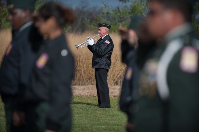 Bugler Tom Molnar, of Washington Crossing, plays taps at the close of the Veterans Day observance ceremony at Washington Crossing National Cemetery Tuesday morning.
