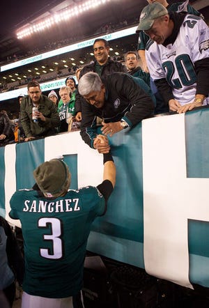 Philadelphia Eagles quarterback Mark Sanchez meets a few fans after wining 45-21 over the Carolina Panthers at Lincoln Financial Field in Philadelphia Monday night.