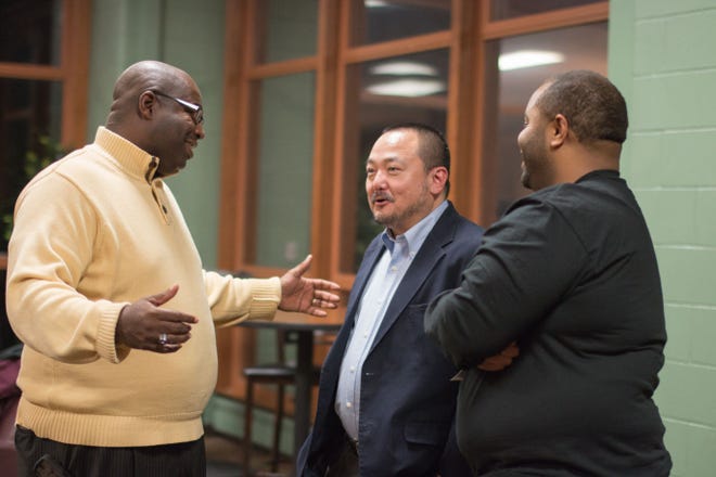 The Rev. Avery J. Damage, left, of South Euclid, Ohio, and Lamont Downs, right, of Beaver Falls speak with the Rev. Soong-Chan Rah after he addressed the Living in Color conference Friday at Geneva College.
