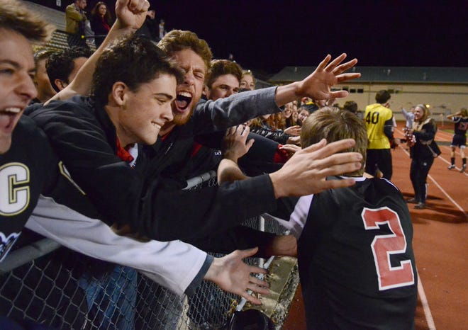 Sewickley Academy boys soccer team celebrate the win with fans after the PIAA playoff match.