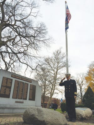 Ulf Hierlwimmer, 69, salutes the war memorial in downtown Holland in Centennial Park on Tuesday, Nov. 11. Hierlwimmer is a U.S. Navy veteran and works as an allergist at Asthma Allergy Center, 844 Washington Ave. JASON BARCZY/SENTINEL STAFF