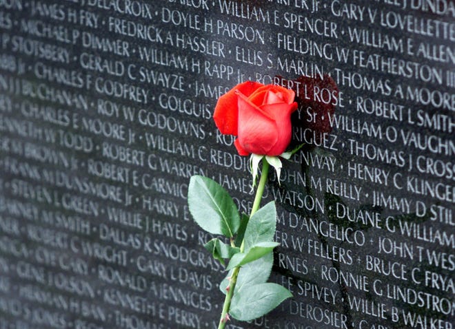 A rose is placed against the names fallen veterans at the Vietnam Veterans Memorial in Washington, D.C.