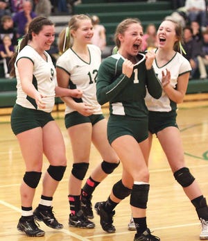 Kaley Smith (1) of Mendon reacts with her teammates after scoring the winning point of the second set Tuesday.