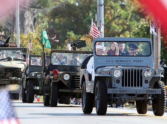 Veterans ride in vintage military vehicles during the 2014 Veterans Day Parade in Panama City on Tuesday.