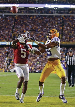 LSU wide receiver Malachi Dupre (15) pulls in a touchdown reception in front of Alabama defensive back Cyrus Jones (5) during the first half of an NCAA college football game in Baton Rouge, La., Saturday, Nov. 8, 2014. (AP Photo/Jonathan Bachman)