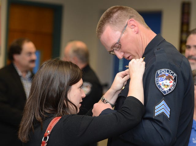 BRIAN D. SANDERFORD • TIMES RECORD / Christy Thompson assists her husband Jason Thompson with the Fort Smith Police Department after he was promoted to sergeant on Monday, Nov.10, 2014. Police Chief Kevin Lindsey announced the promotions of Sgt. Thompson, Maj. Larry Ranells, Capt. Brian Rice and Sgt. Adam Creek during a ceremony at the department. 
 BRIAN D. SANDERFORD • TIMES RECORD / Fort Smith Police Chief Kevin Lindsey, left, and newly promoted Maj. Larry Ranells during a promotion ceremony held at the Police Department on Monday, Nov.10, 2014. Lindsey announced the promotions of Sgt. Adam Creek, Sgt. Jason Thompson and Capt. Brian Rice. 
 BRIAN D. SANDERFORD • TIMES RECORD / Capt. Brian Rice, right, with the Fort Smith Police Department receives the captain badge from Police Chief Kevin Lindsey during a promotion ceremony at the Police Department on Monday, Nov.10, 2014. Lindsey announced the promotions of Rice, Sgt. Adam Creek, Sgt. Jason Thompson, and Maj. Larry Ranells. 
 BRIAN D. SANDERFORD • TIMES RECORD / Fort Smith Police Chief Kevin Lindsey, left, gives Sgt. Adam Creek his new badge during a promotion ceremony at the Police Department on Monday, Nov.10, 2014. Lindsey announced the promotions of Sgt. Creek, Sgt. Jason Thompson, Maj. Larry Ranells and Capt. Brian Rice. 
 BRIAN D. SANDERFORD • TIMES RECORD / Fort Smith Police Chief Kevin Lindsey, left, gives Sgt. Jason Thompson his new badge during a promotion ceremony at the Police Department on Monday, Nov.10, 2014. Lindsey announced the promotions of Thompson, Sgt. Adam Creek, Maj. Larry Ranells and Capt. Brian Rice.