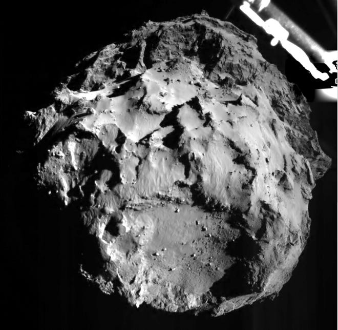 The picture released by the European Space Agency ESA on Wednesday, Nov. 12, 2014 was taken by the ROLIS instrument on Rosetta’s Philae lander during descent from a distance of approximately 3 km from the 4-kilometer-wide (2.5-mile-wide) 67P/Churyumov-Gerasimenko comet. Hundreds of millions of miles from Earth, the European spacecraft made history Wednesday by successfully landing on the icy, dusty surface of a speeding comet.
