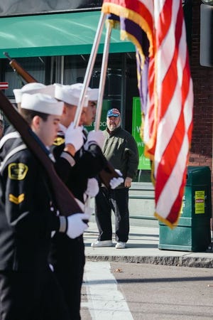 Pat O’Donnell of Quincy watches marchers go by during the Veterans Day parade in Quincy on Tuesday., Nov. 11, 2014.