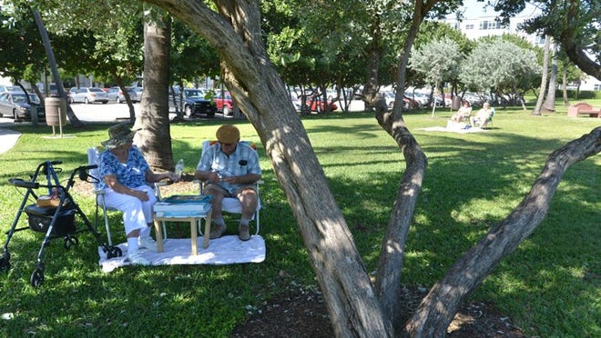 Dolores and Ron Kaphan, who share their time between West Palm Beach and New Jersey, play Scrabble on Thursday in Kreusler Park. One of the proposed ideas is to add more shade canopies to the coastal park.