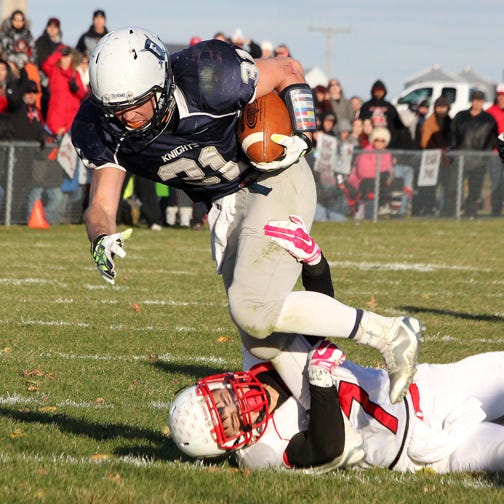 Fieldcrest running back Grant Jochums tries to break through a tackle last week against Momence. Jochums and the Knights will travel to Clifton to face the Central Comets in a Class 2A quarterfinal game Saturday.