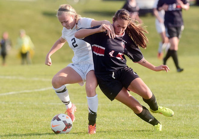 Pomfret School's Duun O'Hara, right, and Groton's Carrie Moore battle for the ball Wednesday during their NEPSAC quarterfinal match in Pomfret. The Griffins lost, 5-1. John Shishmanian/ NorwichBulletin.com