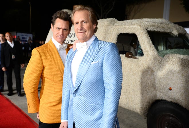Jim Carrey, left, and Jeff Daniels arrive at the premiere of "Dumb and Dumber To" at the Regency Village Theatre on Monday, Nov. 3, 2014, in Los Angeles. (Photo by Jordan Strauss/Invision/AP)