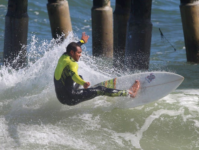 Flagler Beach resident Matt O'Brien rides waves north of the Flagler Beach Pier on Wednesday, Nov. 12, 2014. Many locals are tuning up for this weekend's 15th annual Tommy Tant Memorial Surf Classic taking place Saturday and Sunday in Flagler Beach.