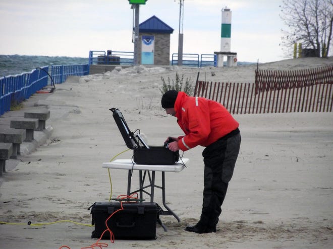 An Ottawa County Sheriff's Office deputy monitors camera and sonar images at Holland State Park along the channel between Lake Michigan and Lake Macatawa on Wednesday, Nov. 12. Jim Hayden/Sentinel staff