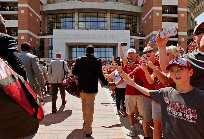 Alabama defensive back Landon Collins (26) high fives fans during the Walk of Champions before the Alabama vs. Florida game at Bryant-Denny Stadium Saturday, Sept. 20, 2014. Michelle Lepianka Carter | The Tuscaloosa News