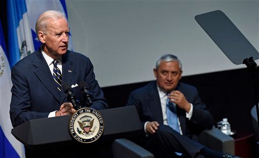 Vice President Joe Biden speaks at the Inter-American Development Bank "Investing in Central America: Opening up Opportunities for Growth" seminar, Friday, Nov. 14, 2014, at the Inter-American Development Bank in Washington. Guatemalan President Otto Perez Molina listens at right. (AP Photo/Susan Walsh)