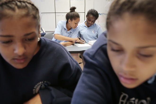 Middle school girls at Our Sisters' School in New Bedford are a study in concentration. PETER PEREIRA/The Standard-Times