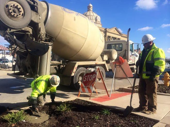 A crew from Illinois Civil Contractors poured concrete for new stop signs on Pulaski Street Friday morning. Phot by The Courier.